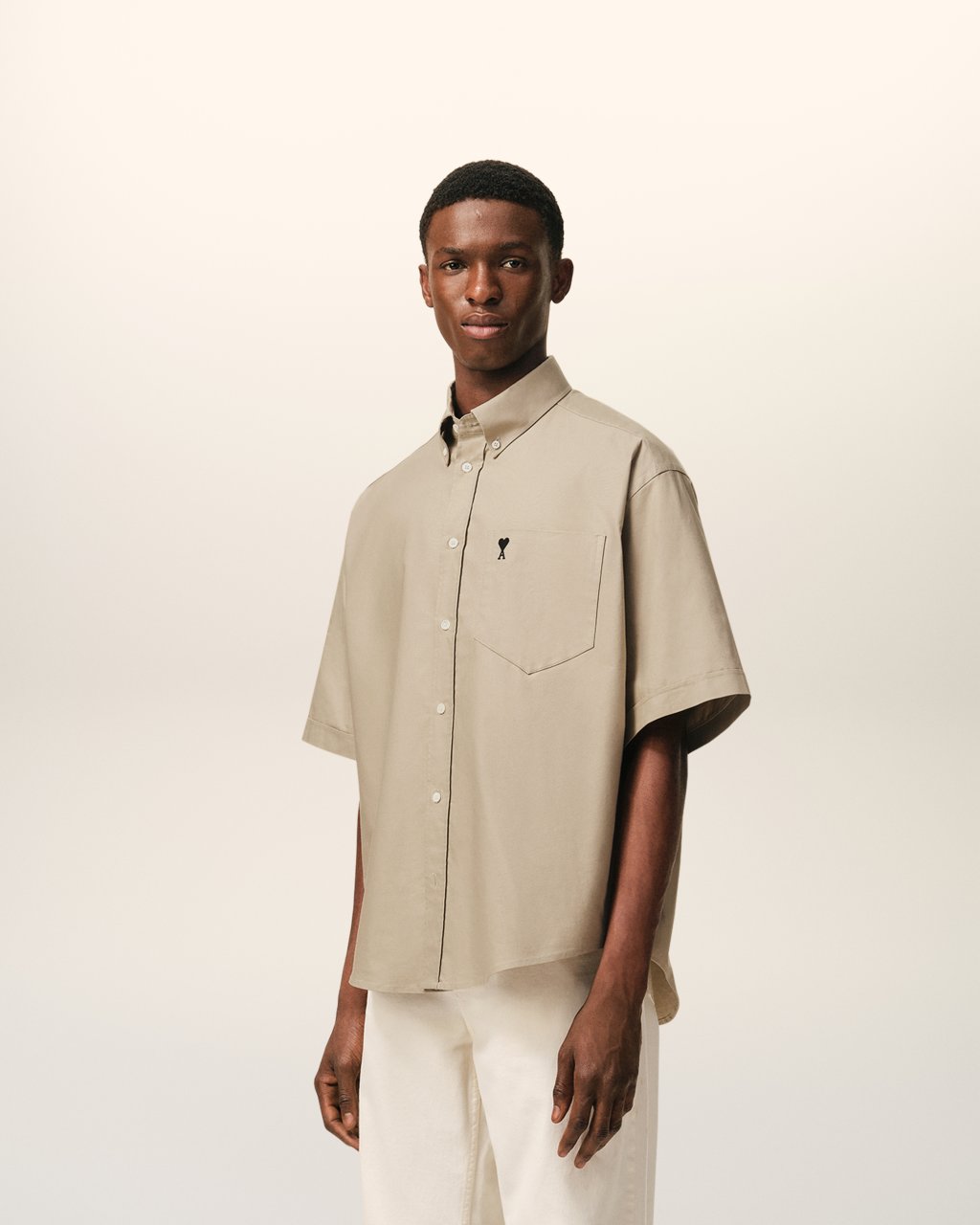 QUOTA -BOXY SHORT SLEEVE SHIRT WITH BUTTON DOWN COLLAR AND EMBROIDERED ADC IN BEIGE TAUPE
